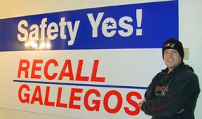 [Flanigan in front of Safety Yes! Recall Gallegos sign]