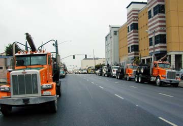 Logging trucks parked on street near courthouse