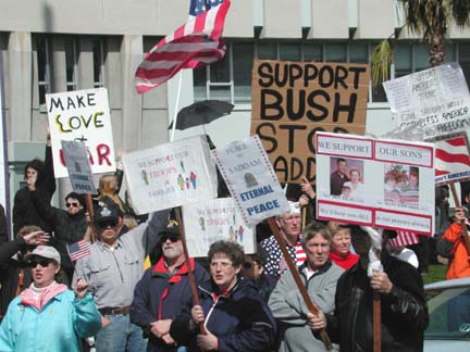 Counter-protesters with signs "Make Love AND war" "Support Bush, Stop Saddam" "We support our troops"