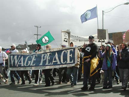 Veterans for Peace march with banner reading "Wage Peace"