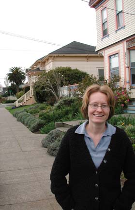 [photo of Amy Stewart in front of house]