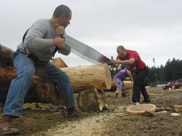 two men sawing log