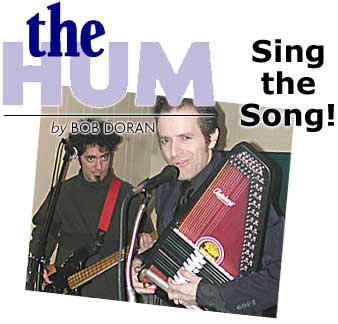 Heading: The Hum by Bob Doran, "Sing the Song", photo of Cory McAbee/Billy Nayer