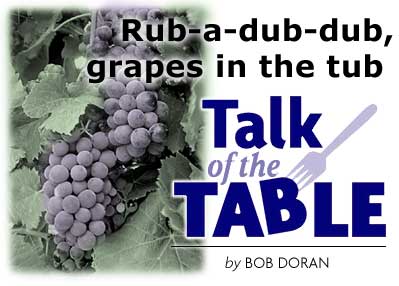 Heading: Talk of the Table, by Bob Doran, Rub-a-dub-dub, grapes in the tub, photo of grapes