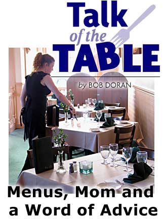 Headig: Talk of the Table, Menus, Mom and a Word of Advice by BOB DORAN, photo of waitress lighting candle in restaurant