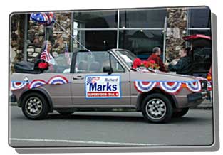 Car decorated with Marks political signs and banners, driving in parade in parade