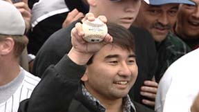 [man holding baseball]