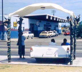 [bus shelter with old car and canopy]