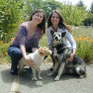 [Jennifer Sanford and Emily Sommerman with two dogs]