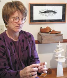 Elaine Benjamin with art objects in background