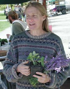 Claudia Holsinger with plants at her booth