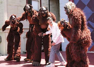 [actor surrounded by four bigfoot creatures]