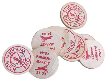 [Wooden coins labeled "One wooden buck" and "NCGA Farmers' Market $1"]