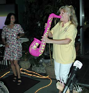 [photo of woman playing sax andwoman dancing]
