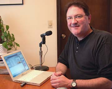 [Ken Conlin with microphone and laptop computer]