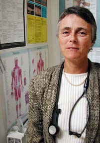 Dr. Ann Lindsay with stethoscope, standing in office