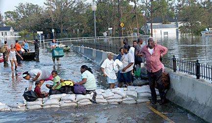 Stranded residents in Jefferson Parish are brought to an elevated bridge area by boat to await rescue. Photo by Win Henderson/FEMA.
