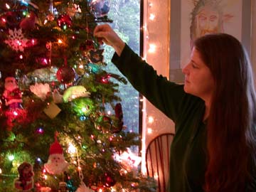 [photo of Tanya Hunt hanging ornament on Christmas tree]