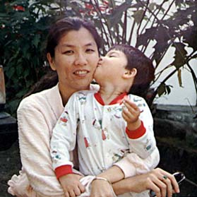 Linda with daughter giving her a kiss
