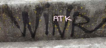 ["WINR" and "ATK" tags on cement]