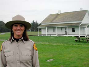 Edie Carhart in her parks uniform, standing in front of the Fort Humboldt hospital/museum building