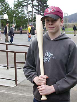 [photo: Matthew Perkins holding his homemade baseball bat]