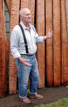 [Bill Boak standing in front of curly redwood boards]