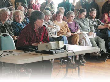 [Kristi Wrigley speaking in front of board]