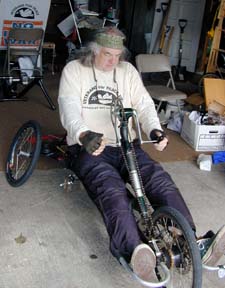 Willson sitting on a custom-made low tricycle 