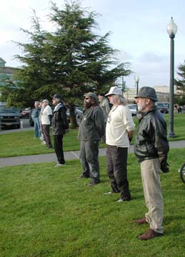 Veterans for Peace standing in a line on the grass of the Arcata Plaza