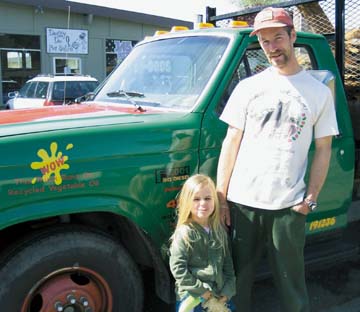[Ian Sigman with daughter standing in front of truck]