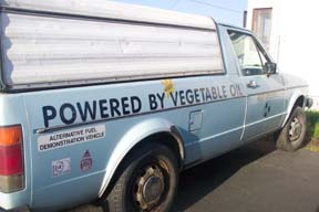 [Volkswagen truck with "powered by vegetable oil" painted on the side]