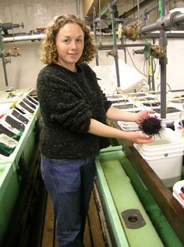 [Rachel Moore holding urchin, in lab]