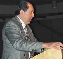 [John Porter standing at podium]