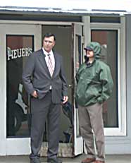 Photo of  EPD Cheif Dave Douglas and a detective stand outside the ntrance of Moore's apartment, several hours after the shooting.