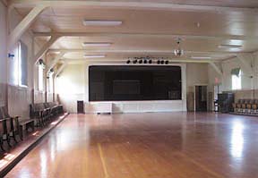 [inside main hall: wood floors, stage]