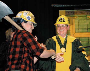 Marching Lumberjacks Axe Major holding axe, HSU President Rollin Richmond wearing hard hat and gown