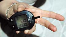 [person showing glucose meter reading of 98]
