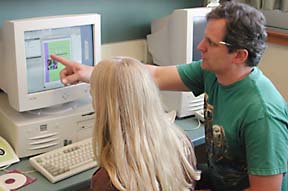 Armin-Hoiland works with student on computer