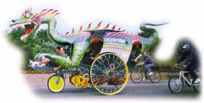 dragon-shaped kinetic sculpture on the road with bicylists