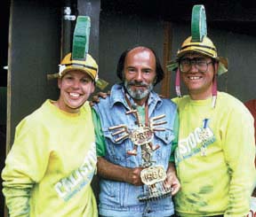 Micki Flatmo, Bob Pussey and Duane Flatmo standing next to each other, holding trophy