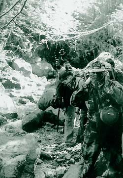 [photo of hikers along creek]