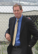 photo of FOX reporter Carl Cameron smokes while he waits.