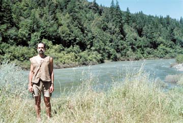 [David Rose standing in grass in front of river]