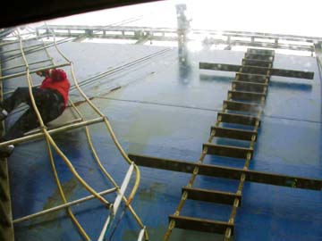 [pilot climbing ladders on side of ship]