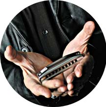 Photo of hands holding a harmonica