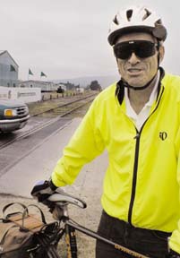 [Rick Knapp wearing cycling clothing, helmet and standing near bike]