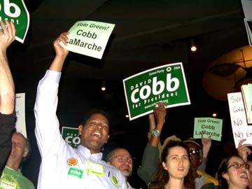 [People at convention holding 'David Cobb for President' signs]