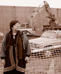 Joyce Plath standing next to construction equipment