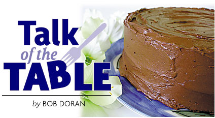 Heading: Talk of the Table by Bob Doran, photo of chocolate cake